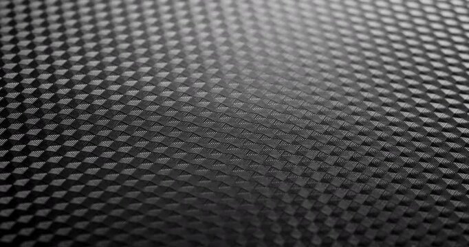 Carbon Texture Seamless Loop. Close-up of premium black carbon fiber weave with subtle light shift, creating a high-tech, endlessly background.