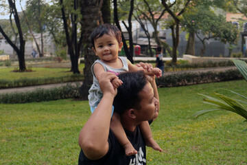 Happy Dad and Toddler Bonding Outdoors