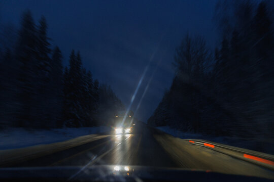 Windshield Glare With Passing Headlights Streaks And Interior Reflections, Smeared Glass And Icy Smears