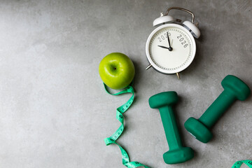 New Year for New Changes Healthy 2026. Fresh vegetable fruits and healthy food for sport equipment for women diet slimming weight loss. Healthy and Holiday Concept