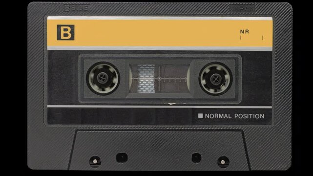 Audio Cassette Rewind to End and Stop. Vintage compact cassette fast-forwarding to the end of side B with final tape stop.