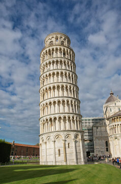 View of the iconic Leaning Tower of Pisa standing proudly against a backdrop of a vibrant blue sky, showcasing its unique architectural marvel, Pisa, Tuscany, Italy.