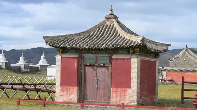 Detailed view of a temple pavilion at Erdene Zuu Monastery, Mongolia. The ancient structure features a traditional curved roof and red walls, showcasing Buddhist architectural heritage.