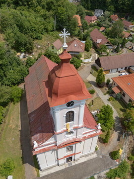 Aerial view of St. Luke's Church, its red roof standing out against the lush green backdrop, a beacon of faith and history, Sklene Teplice, Banska Bystrica Region, Slovakia.
