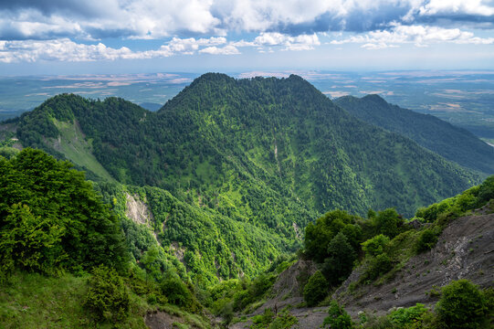 Lush green mountains and forest slopes near Gabala, Azerbaijan, captured in bright daylight.