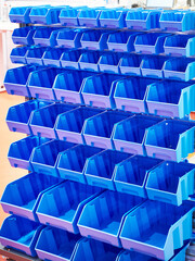 Rack with plastic trays for storing small parts