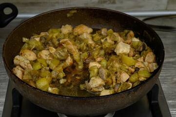 Chicken and Zucchini Stir-Fry Cooking in a Pan on a Kitchen Stove. Cooking Process