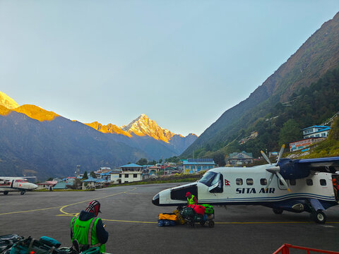 Lukla, Nepal - October 13, 2025: Sita Air aircraft parked at Lukla Airport, surrounded by majestic mountains, showcasing the beauty of Nepal's landscape and aviation in the Himalayas