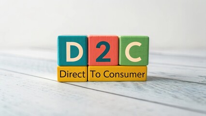 Colorful building blocks arranged to spell out D2C for Direct To Consumer marketing concept on a rustic wooden surface