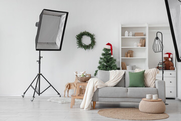 Photo shoot of living room with sofa and Christmas tree in studio