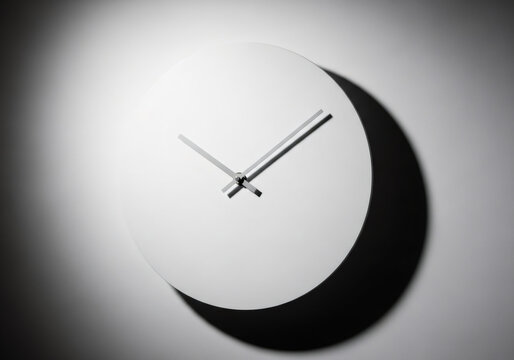Minimalist white clock with dark shadow on a light wall. Simple time management concept. Modern interior decor and abstract design.