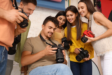 Group of photographers looking at pictures during courses in studio