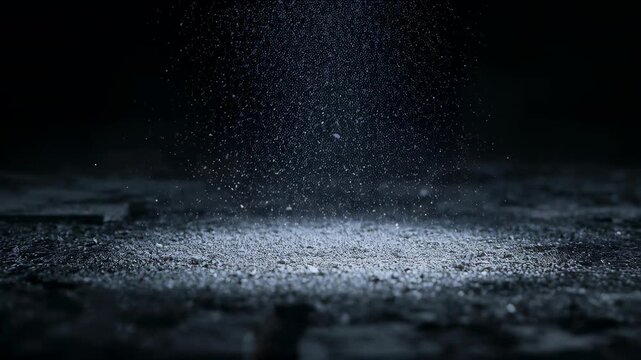 Revealing falling dust forming shallow circular pile on worn floor under narrow beam of light
