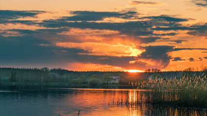 Beautiful sunset over a lake with a house in the background