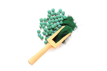 Wooden scoop with spirulina powder and tablets on white background