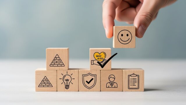 Hand stacking wooden blocks with icons representing business success innovation security teamwork and happiness symbolizing growth and achievement