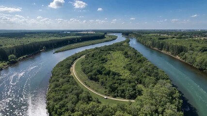 Sweeping drone starting sweep revealing river peninsula and car moving on road, surveying land - Powered by Adobe