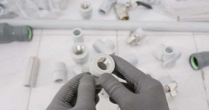 Technician points inside plastic adapter showing clean bore. Plumber gloved hand highlights thread pitch and confirms O ring groove seating face in correct position