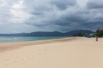 Yalong Bay (Asian Dragon Bay) beach on Hainan Island, Sanya, China. Sandy shore, gentle waves, and distant mountains. Coastal landscape, November 2025. Travel to Hainan, China discover concept.
