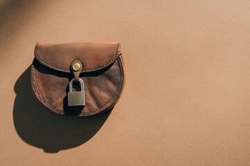 Secure your finances with this stylish leather purse and padlock, perfect for financial security concepts or safeguarding personal belongings, protection
