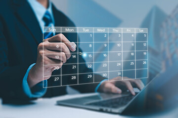 A business professional interacting with a futuristic digital calendar interface above a laptop, symbolizing scheduling, planning, productivity, and modern time-management in corporate workflow.