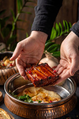 Placing roasted meat onto flatbread serving