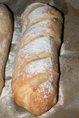 Close up of fresh homemade baguette sub rolls bread that has come out of the oven and still on baking tray