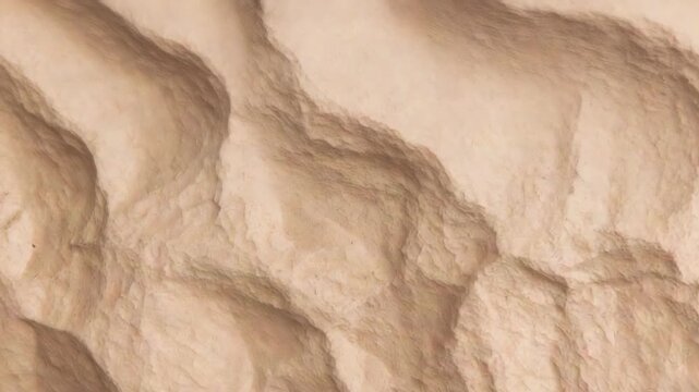 Panning camera moving right and down on closeup beige nodules, showing creases and lighting