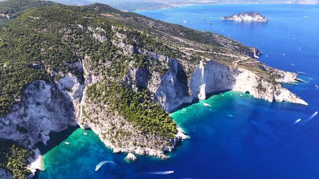 Aerial drone cinematic video of paradise sea caves of Keri with white cliffs and spectacular landscape creating a blue lagoon a true tourist attraction for yachts and boats, Zakinthos, Ionian, Greece