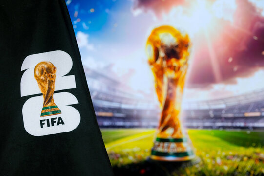 FIFA World Cup 2026 official event logo on a black background with a colorful blurred scene and trophy in the background