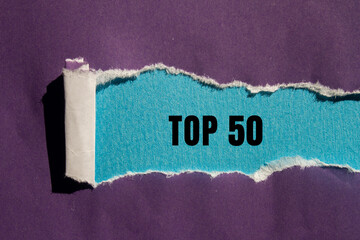 Top 50 message written on ripped torn paper background. Conceptual Top 50 symbol. Copy space.