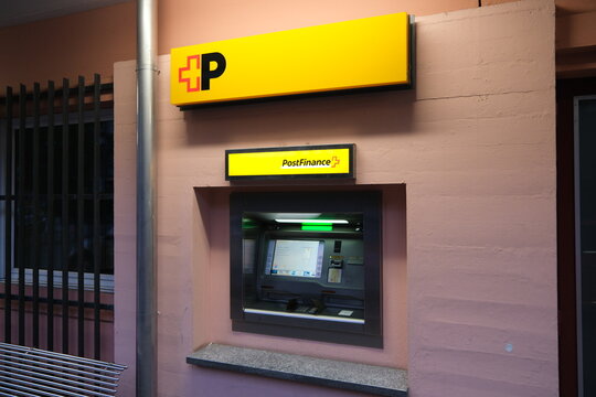 Lugano,Switzerland-Sep.30th 2025: PostFinance ATM with brand logo