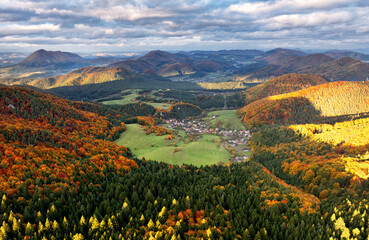 Aerial view of a mountains and hills landscape with vineyard and countryside at sunset in autumn colours, Slovakia
