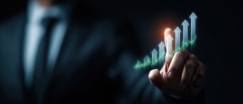 Businessman hand pointing at glowing green ascending arrow graph indicating positive business trend and rapid growth - Powered by Adobe