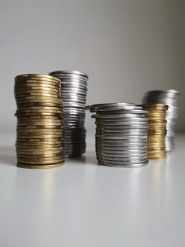 Silver and copper coins stacks on white background