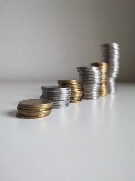Coins towers composition on white background