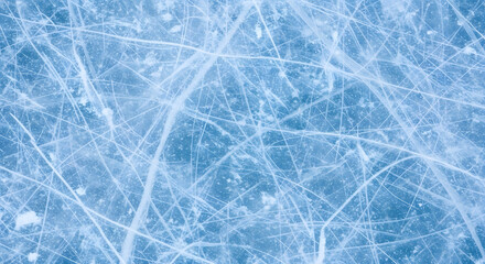 Abstract blue background of a cold winter texture with frozen ice and snow crystals on a glass surface