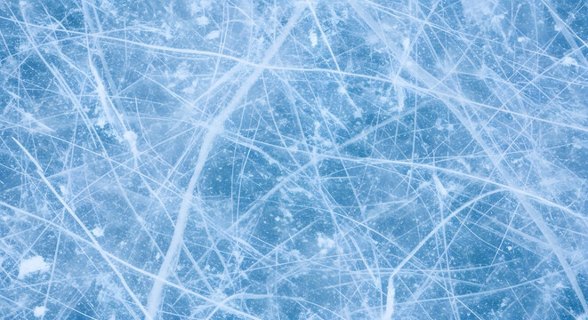 Abstract blue background of a cold winter texture with frozen ice and snow crystals on a glass surface