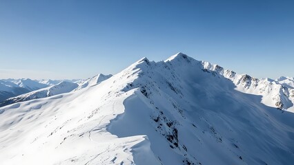 Majestic snow covered mountain peak under a clear blue sky in a vast winter alpine landscape