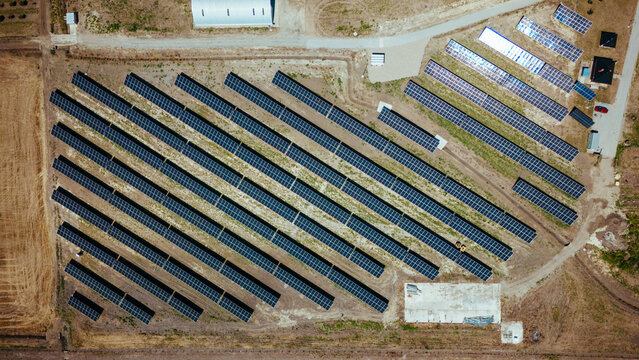 Aerial view of solar panels reflecting the sunlight, positioned in rows across the landscape, generating clean energy, Belgrade, City of Belgrade, Serbia.