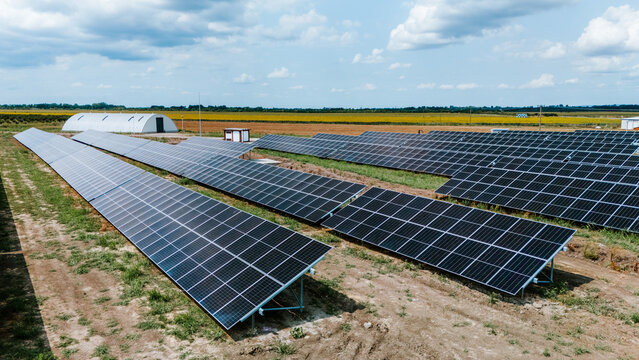 Aerial view of solar panels stretching across the landscape, catching the sunlight under a vast sky, Belgrade, City of Belgrade, Serbia.