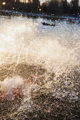 Icy Lake Splash During Polar Plunge, Colossal Spray Engulfing Daring Swimmer Near Drifting Ice, Silhouetted © Northern life