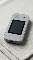 Minimalist Gray Digital Gadget on a Neutral Linen Fabric Surface