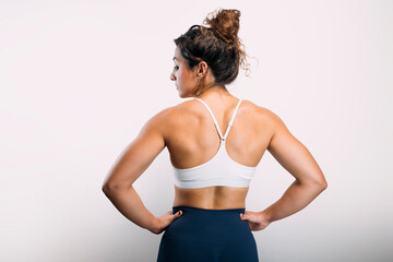 Obraz premium Woman showing strong muscular back on white background