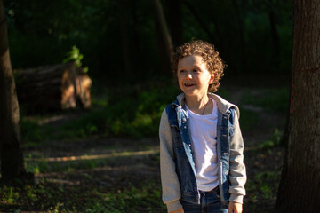 Inquisitive boy exploring something in public park. Park setting and boy wonder are perfect for themes of adventure and exploration. High quality photo.