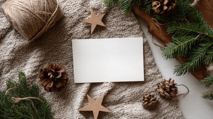 Horizontal A5 greeting card mockup in rustic woodland Christmas flat lay with evergreen branches, cedar cones, twine and wooden stars in earthy tones