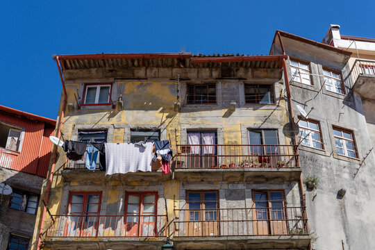 Old apartment building facade with laundry hanging in Porto, Portugal