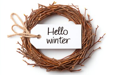 Rustic twig wreath with handwritten hello winter tag isolated on white background for seasonal decor