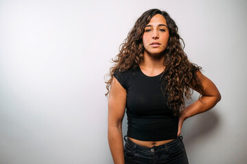 Confident young woman with curly hair standing
