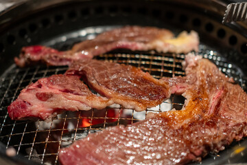 Hanwoo Beef, marbled Korean Style Meat on the Grill. BBQ rare meat with soft focus